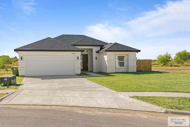 view of front of house with a front yard and a garage