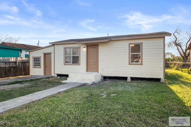 bungalow featuring a front yard and fence