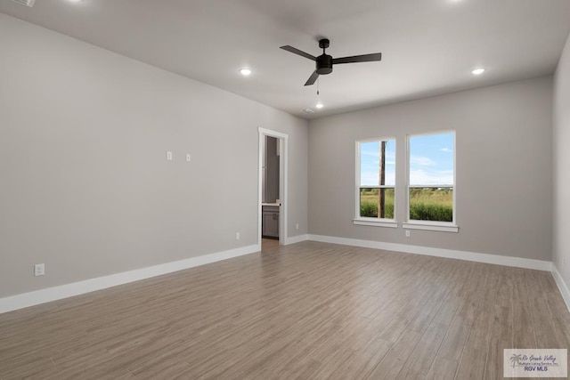 spare room with ceiling fan and light hardwood / wood-style floors