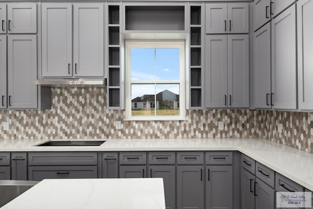 kitchen with backsplash, gray cabinets, and black electric cooktop