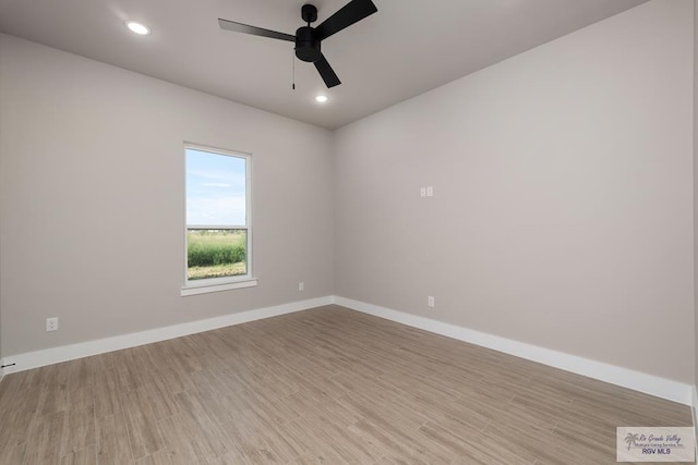 spare room featuring light wood-type flooring and ceiling fan