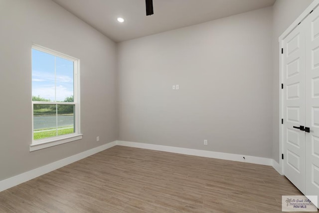 unfurnished room featuring ceiling fan and light wood-type flooring