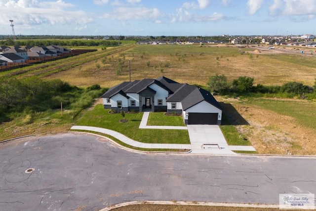 birds eye view of property with a rural view