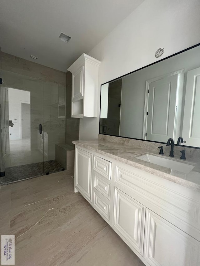 bathroom with vanity, hardwood / wood-style flooring, and walk in shower