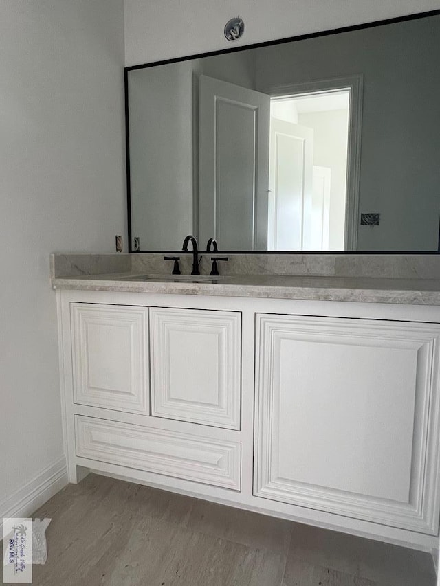 bathroom featuring hardwood / wood-style floors and vanity