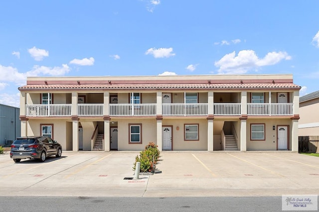 106 E Campeche St Unit A2, South Padre Island, TX 78597 - view of property with stairway and uncovered parking