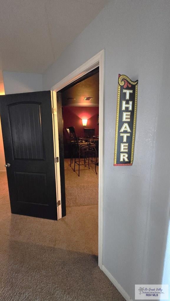 hallway with carpet floors