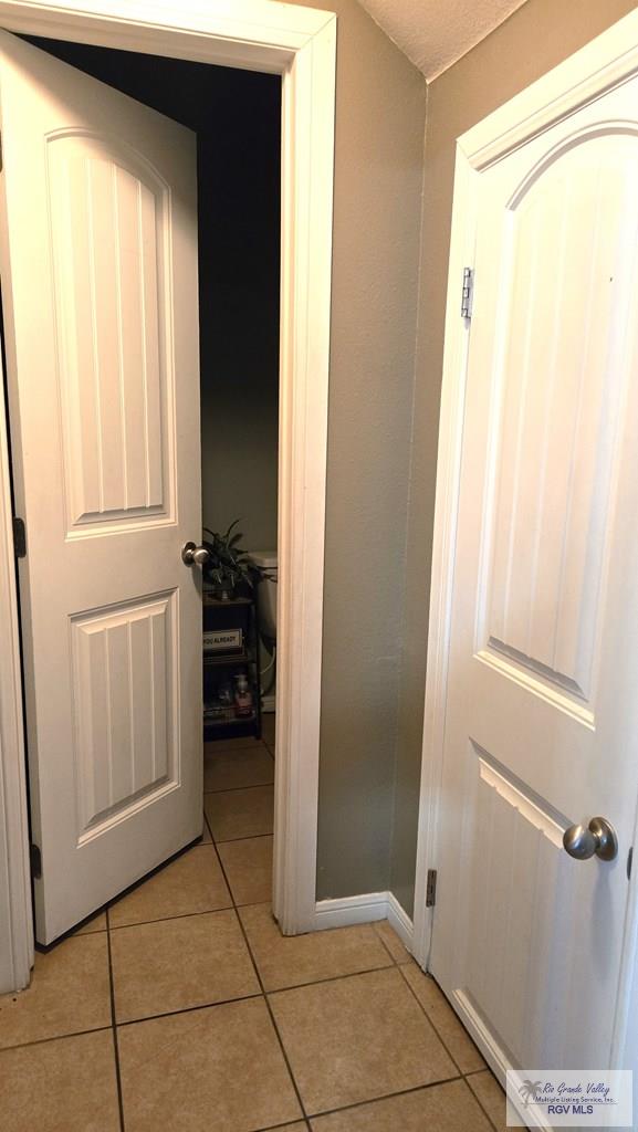 corridor with light tile patterned flooring