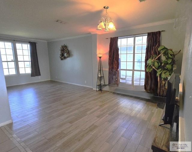 unfurnished living room with a chandelier, wood-type flooring, and ornamental molding