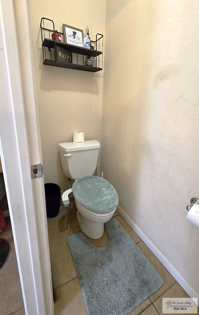 bathroom with toilet and tile patterned floors