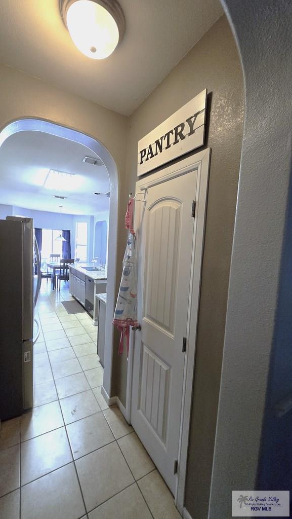 hallway with light tile patterned flooring