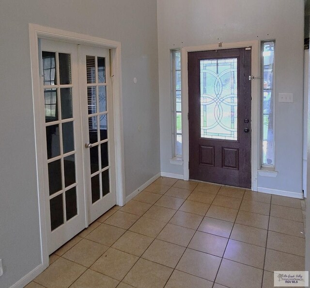 tiled entrance foyer featuring french doors