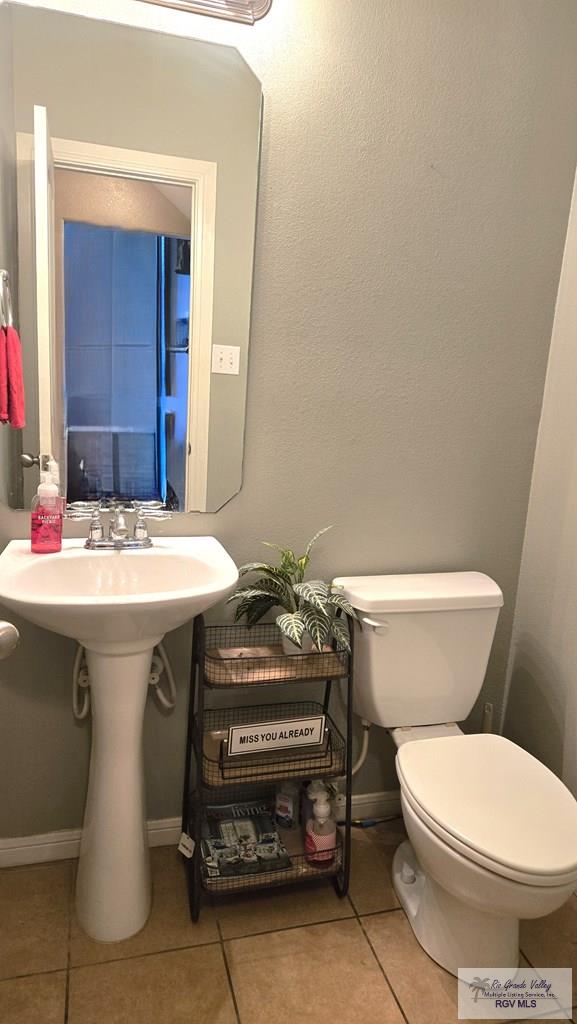 bathroom featuring tile patterned floors and toilet