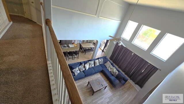 staircase featuring ceiling fan and a high ceiling