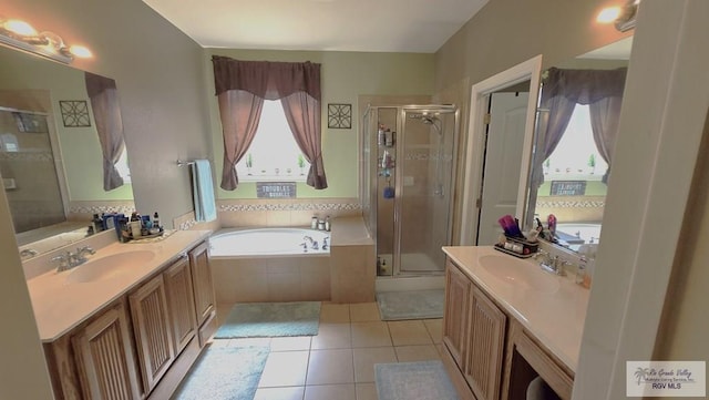 bathroom with tile patterned flooring, vanity, and separate shower and tub