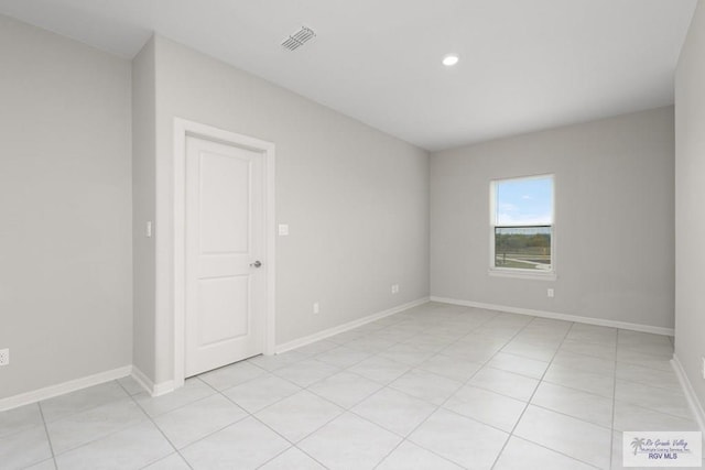 spare room featuring visible vents, baseboards, and light tile patterned floors