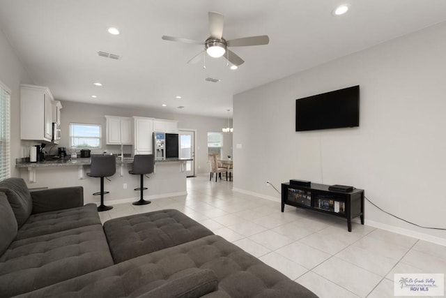 living room featuring light tile patterned floors, recessed lighting, visible vents, baseboards, and a ceiling fan