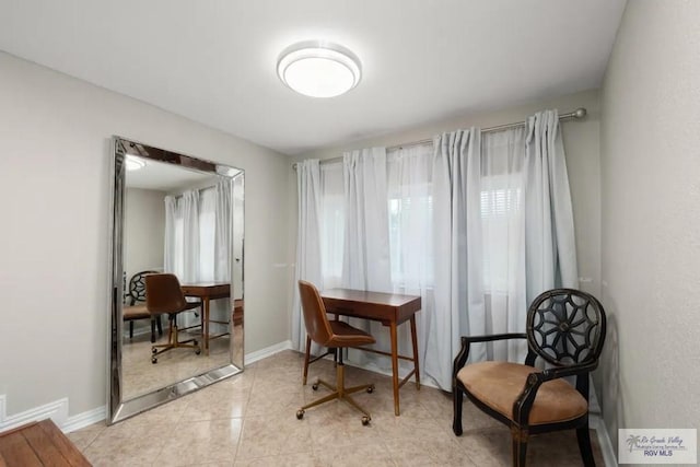 living area featuring plenty of natural light and light tile patterned floors