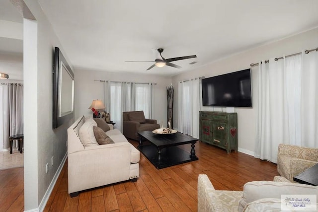 living room with hardwood / wood-style flooring and ceiling fan