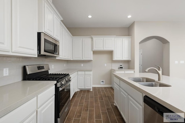 kitchen featuring white cabinetry, sink, dark wood-type flooring, and appliances with stainless steel finishes