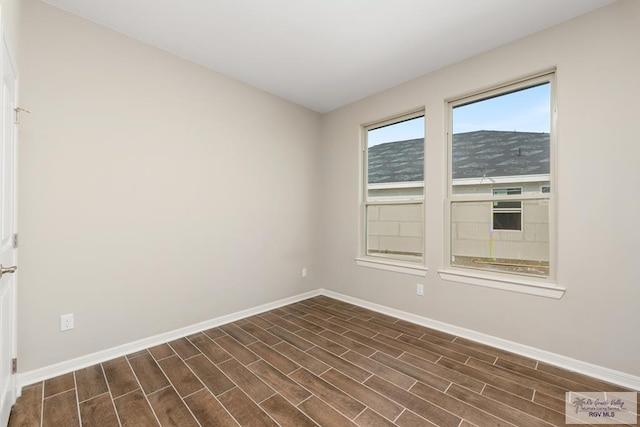 spare room with a mountain view and dark hardwood / wood-style floors