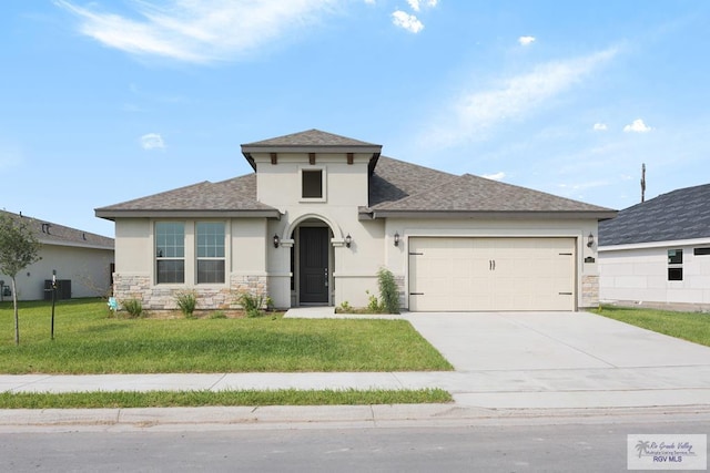 view of front of house featuring a garage and a front lawn