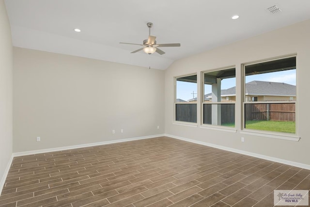 spare room with lofted ceiling, ceiling fan, and dark hardwood / wood-style floors