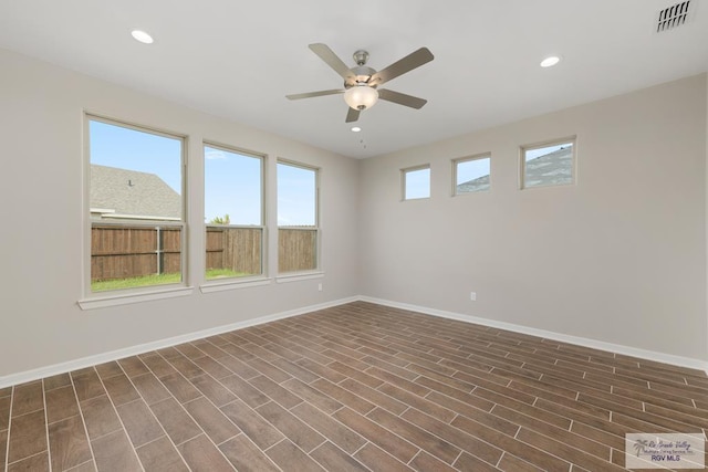 unfurnished room with dark hardwood / wood-style flooring and ceiling fan