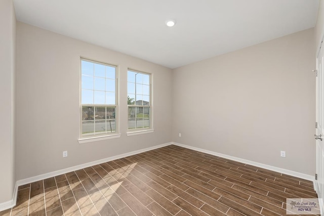 spare room featuring dark hardwood / wood-style flooring