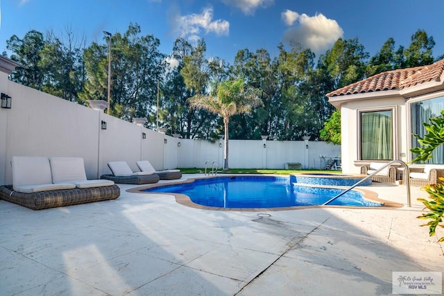 view of pool featuring a patio