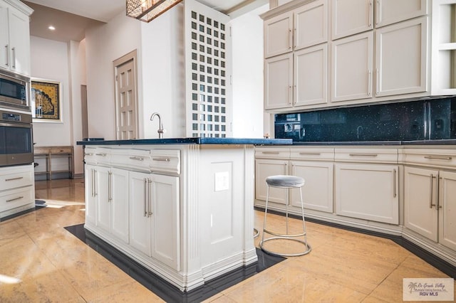 kitchen featuring tasteful backsplash, stainless steel appliances, sink, and light tile patterned floors