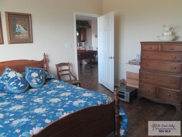 bedroom with dark hardwood / wood-style flooring