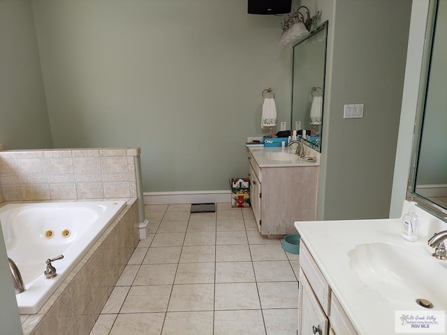 bathroom with vanity, a relaxing tiled tub, and tile patterned floors