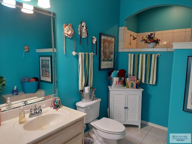 bathroom with tile patterned flooring, vanity, and toilet