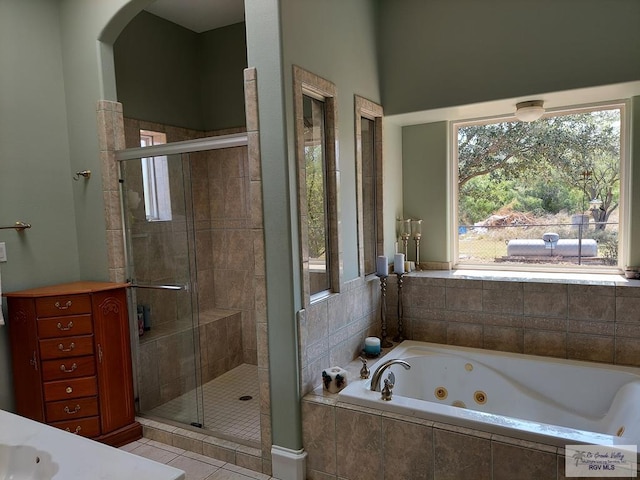 bathroom with separate shower and tub, tile patterned floors, and a healthy amount of sunlight