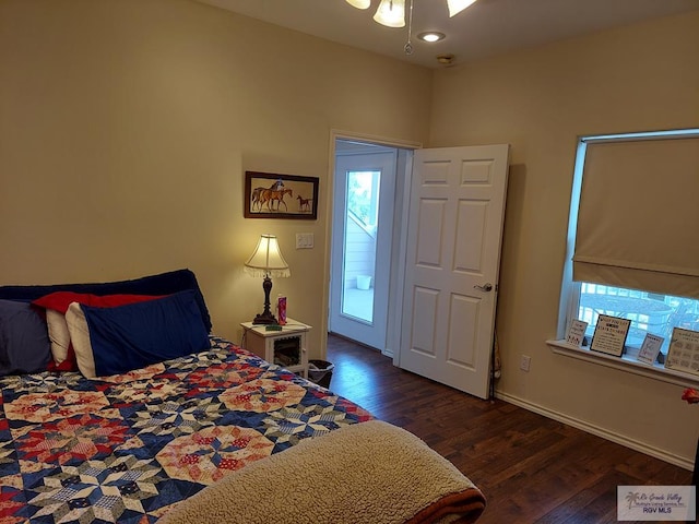 bedroom featuring ceiling fan and dark wood-type flooring