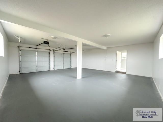 garage featuring baseboards and a garage door opener