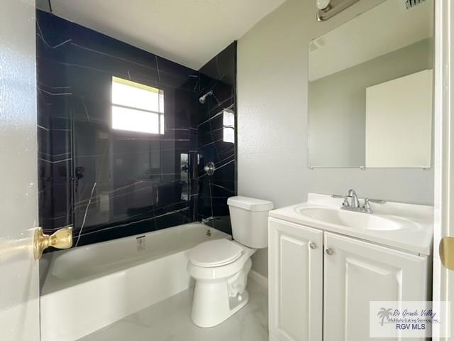 bathroom featuring toilet, washtub / shower combination, and vanity