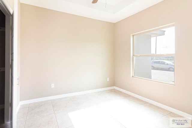 tiled empty room with ceiling fan