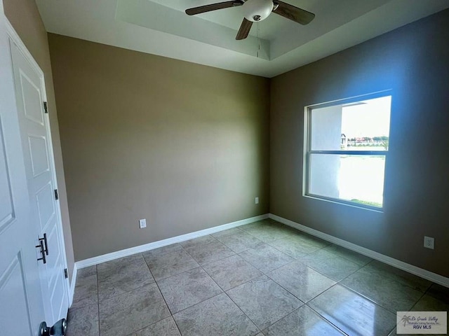 empty room featuring light tile patterned floors and ceiling fan