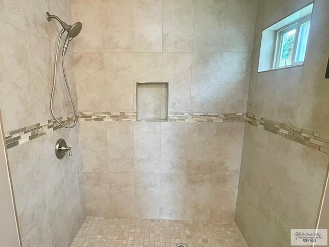 bathroom with tiled shower