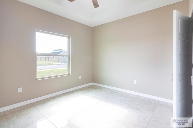 tiled empty room with ceiling fan and a healthy amount of sunlight