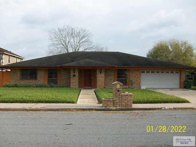 single story home with a garage and a front yard