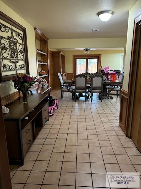 dining room with ceiling fan and light tile patterned flooring