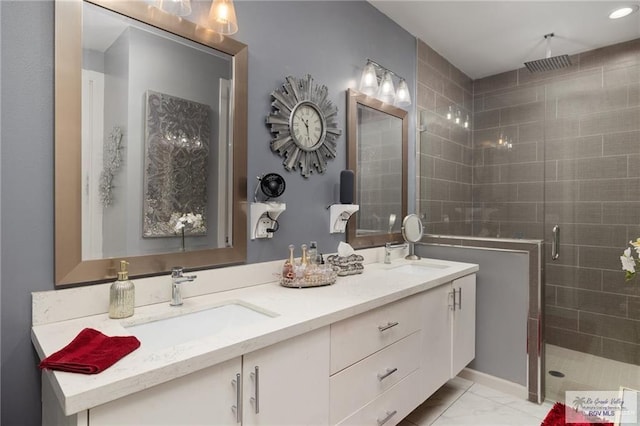 bathroom featuring a shower stall, double vanity, and marble look tile flooring