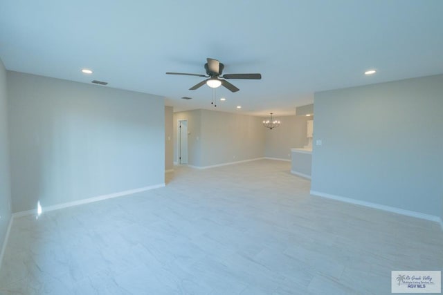 empty room featuring ceiling fan with notable chandelier, baseboards, visible vents, and recessed lighting