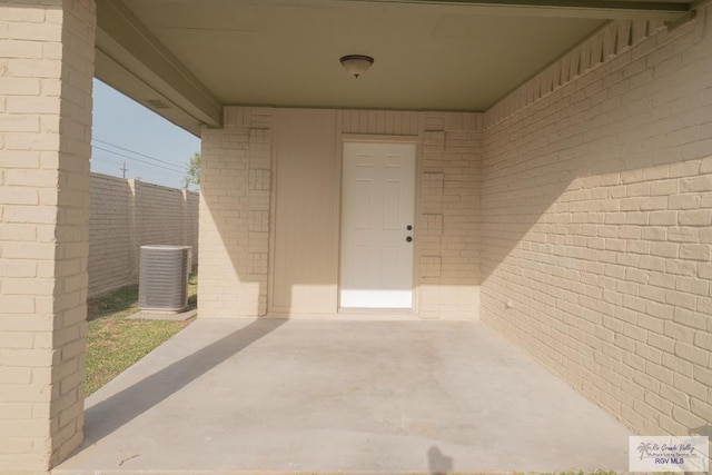 view of patio with cooling unit and fence