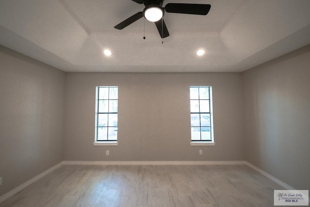 empty room with baseboards, light wood-type flooring, recessed lighting, and a ceiling fan