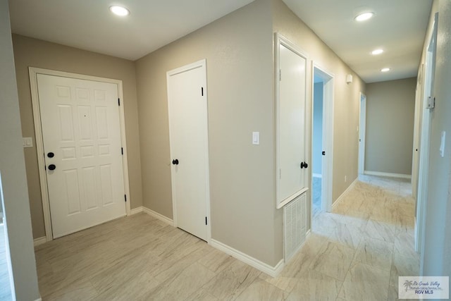 hall featuring visible vents, baseboards, and recessed lighting