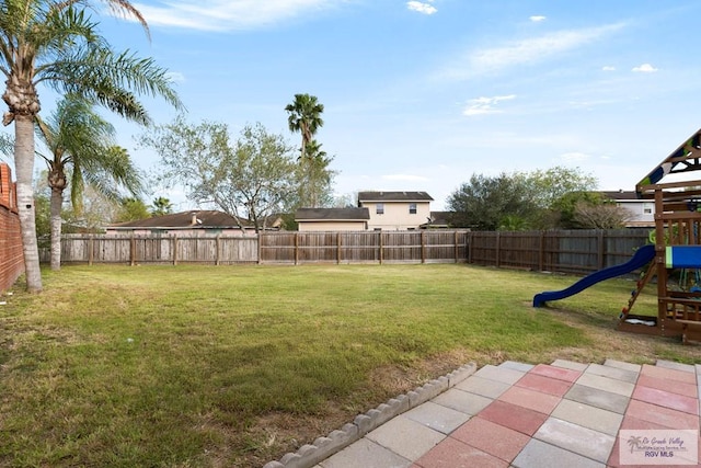 view of yard with a playground and a patio